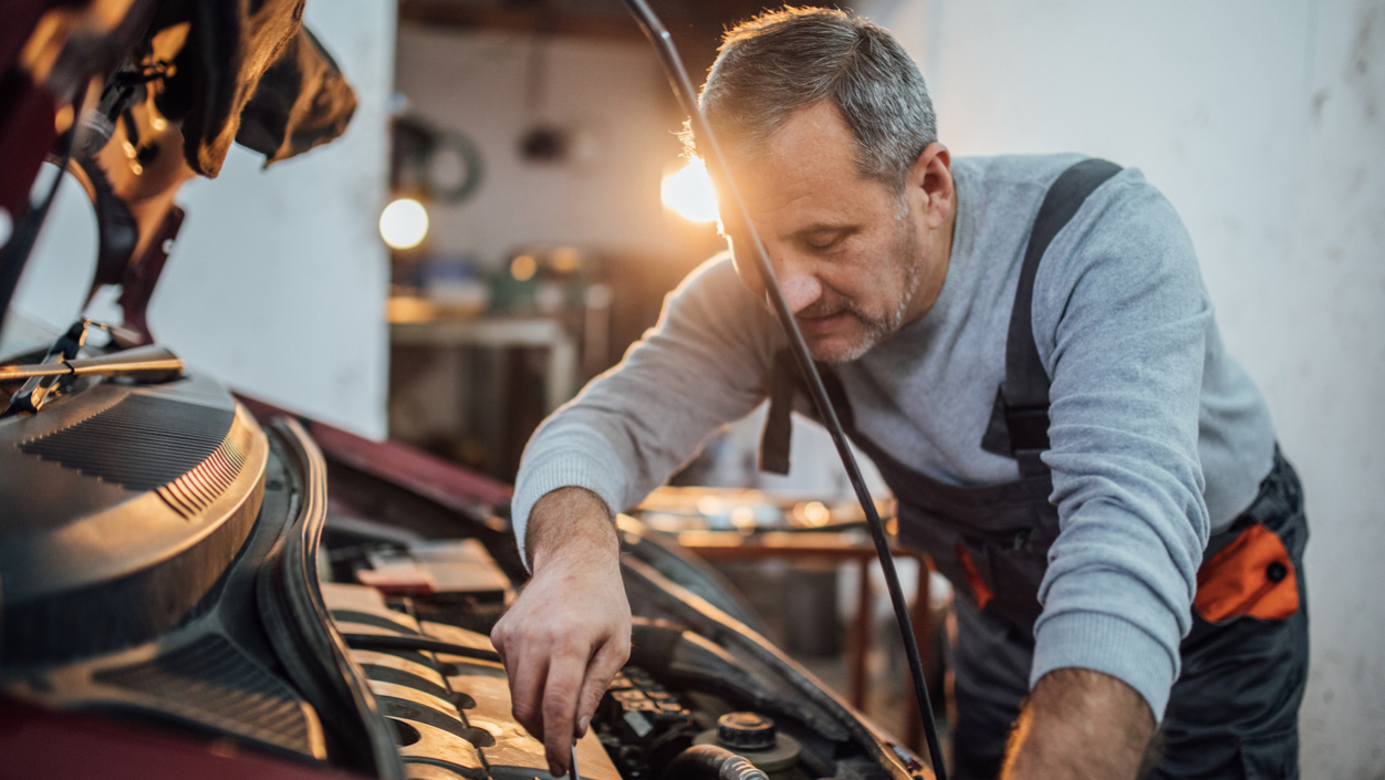 Car mechanic working on an engine