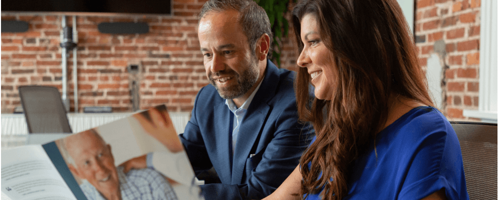 Jose Ortiz and Missy Miller of the Medical Outreach team at Asbestos.com look at the mesothelioma packet
