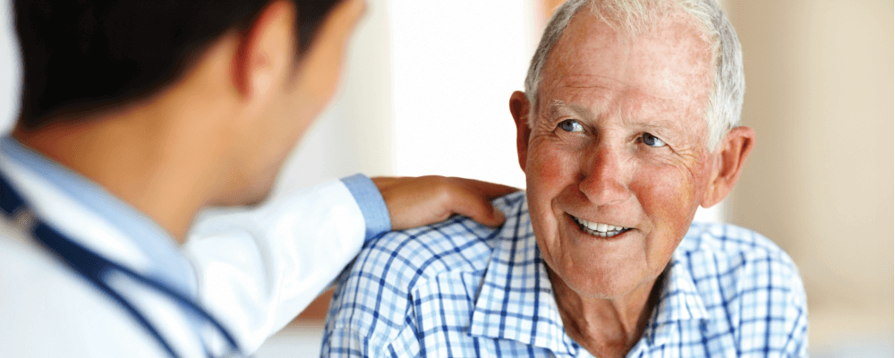 Older patient smiling at a doctor